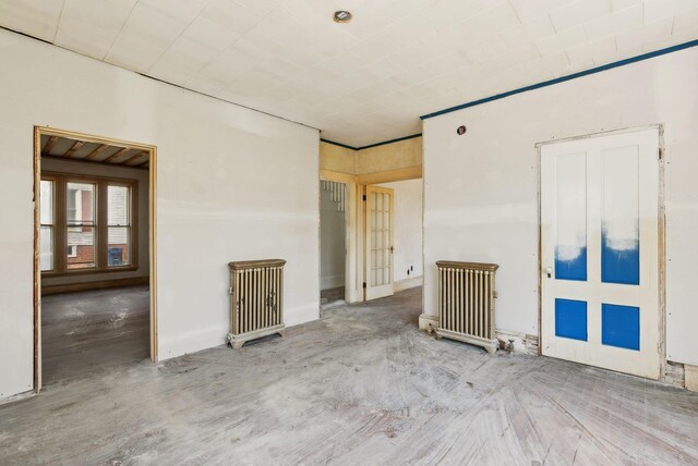 244 Concord St W, Portland, ME 04103 - empty room with radiator heating unit and wood finished floors