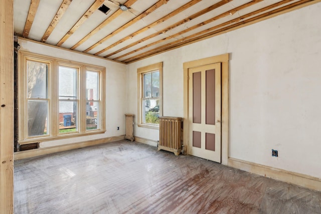 244 Concord St W, Portland, ME 04103 - empty room featuring radiator and wood finished floors