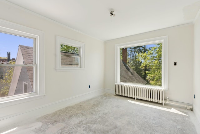 244 Concord St W, Portland, ME 04103 - spare room with radiator heating unit, healthy amount of natural light, ornamental molding, baseboards, and carpet