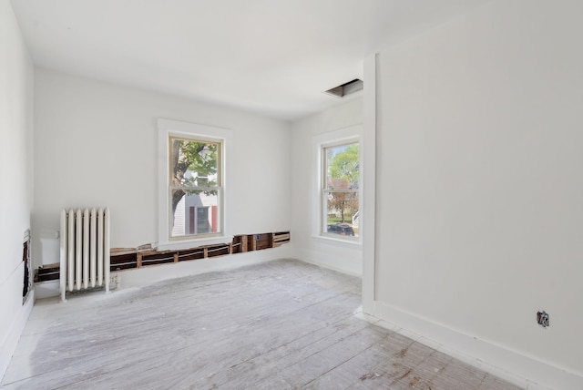 244 Concord St W, Portland, ME 04103 - spare room featuring radiator, wood finished floors, and baseboards