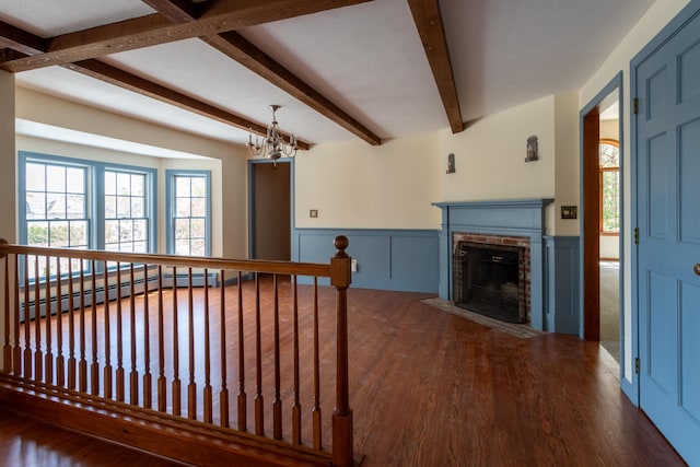 9 Ocean View Cir, Saco, ME 04072 - living area featuring baseboard heating, beam ceiling, wood finished floors, wainscoting, and healthy amount of natural light
