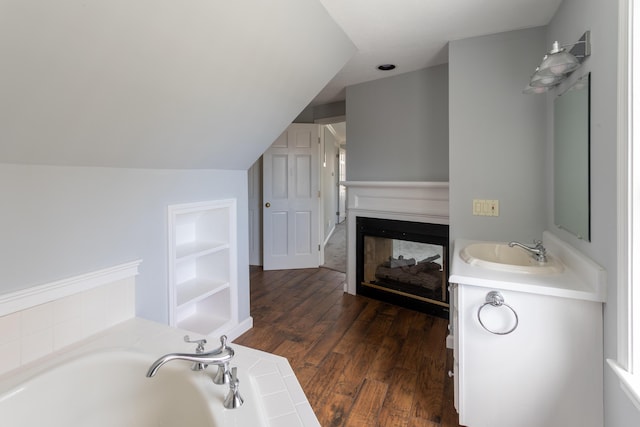 9 Ocean View Cir, Saco, ME 04072 - full bathroom with a sink, a garden tub, a multi sided fireplace, wood finished floors, and built in features