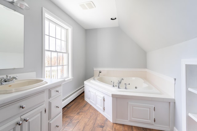 9 Ocean View Cir, Saco, ME 04072 - bathroom with baseboard heating, lofted ceiling, a garden tub, vanity, and wood finished floors
