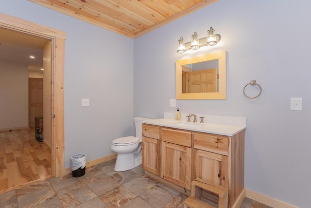26 Christen Rd, Kingfield, ME 04947 - bathroom with baseboards, wood ceiling, vanity, and toilet