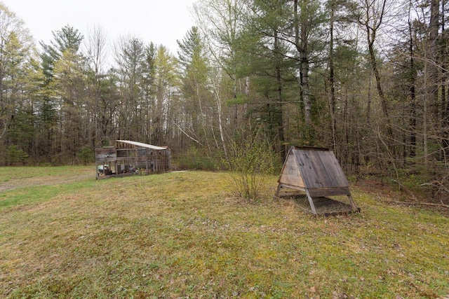 26 Christen Rd, Kingfield, ME 04947 - view of grassy yard featuring a forest view and an outbuilding