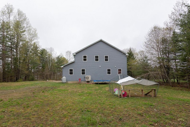 26 Christen Rd, Kingfield, ME 04947 - view of property exterior with a lawn and a trampoline