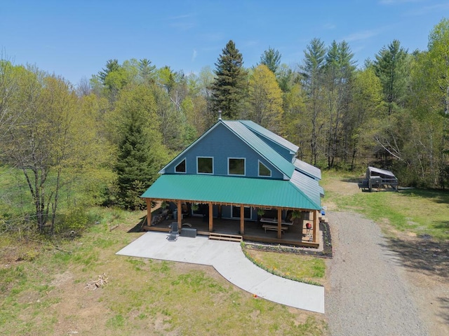 26 Christen Rd, Kingfield, ME 04947 - view of front facade with a view of trees, metal roof, and a front lawn
