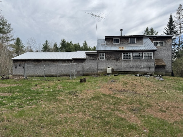 7 Howard Siding Ln, Abbot, ME 04406 - back of property featuring metal roof and a lawn