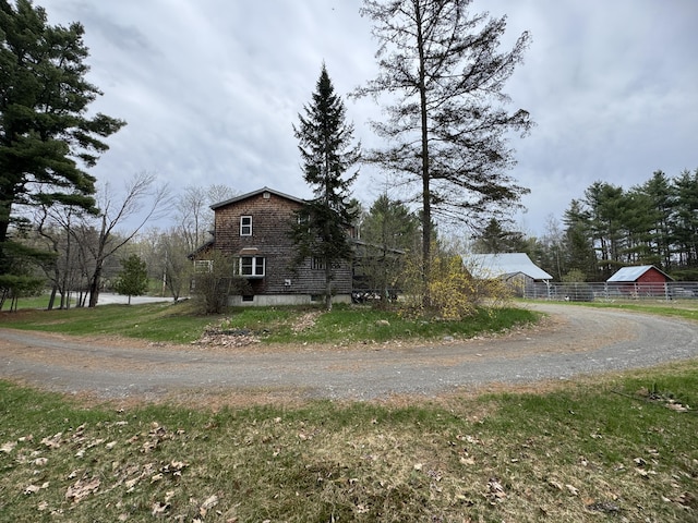 7 Howard Siding Ln, Abbot, ME 04406 - view of side of home featuring fence, driveway, an outdoor structure, and a barn