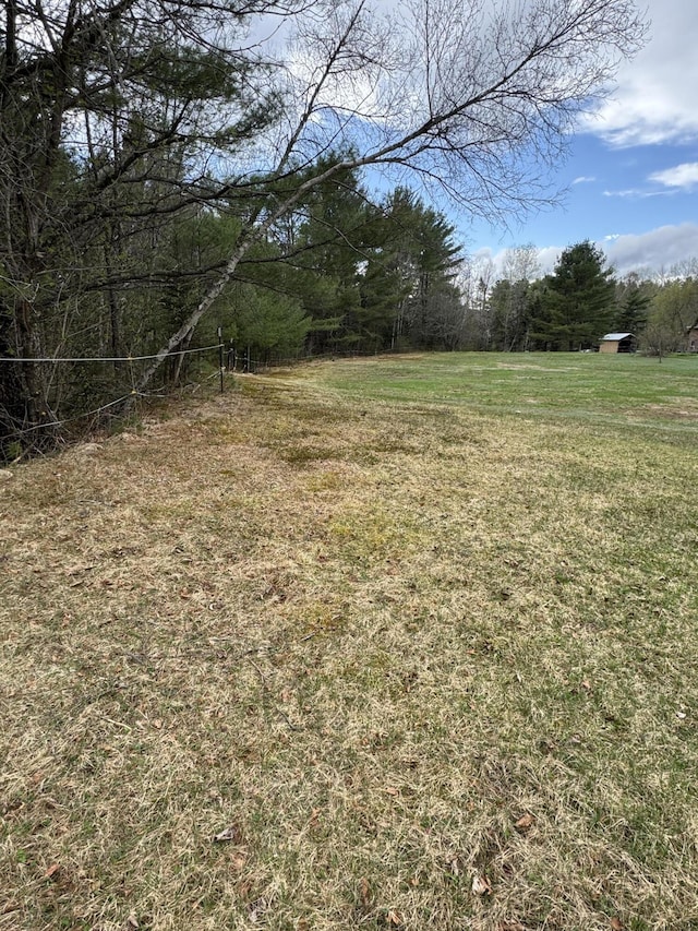 7 Howard Siding Ln, Abbot, ME 04406 - view of grassy yard featuring a forest view
