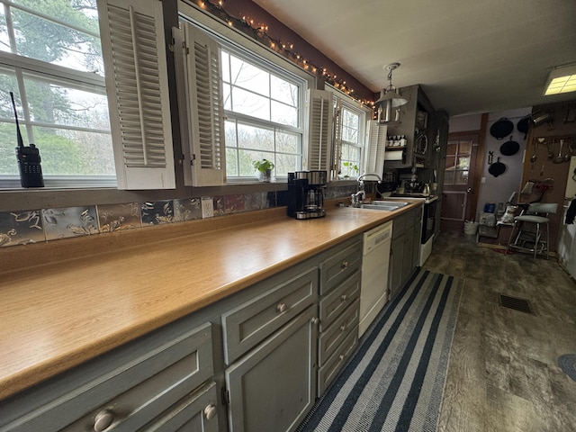 7 Howard Siding Ln, Abbot, ME 04406 - kitchen featuring a sink, dishwasher, electric range oven, dark wood-type flooring, and decorative light fixtures