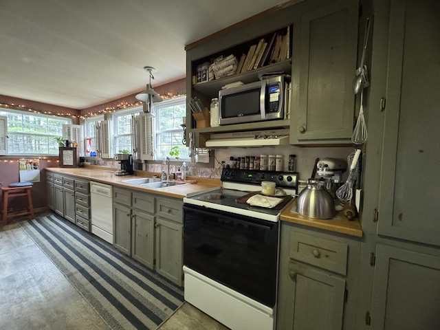 7 Howard Siding Ln, Abbot, ME 04406 - kitchen featuring range with electric stovetop, stainless steel microwave, dishwasher, a sink, and plenty of natural light