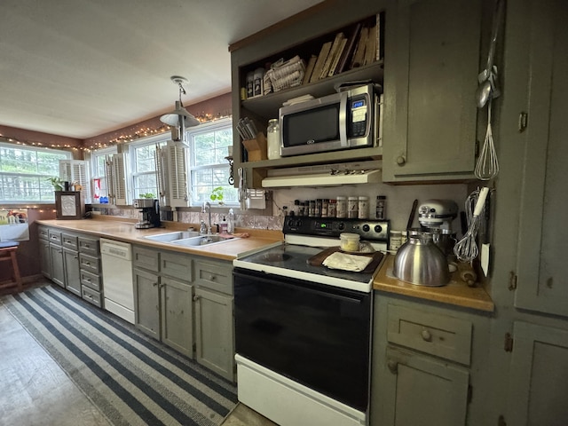 7 Howard Siding Ln, Abbot, ME 04406 - kitchen featuring black range with electric stovetop, stainless steel microwave, dishwasher, a sink, and plenty of natural light