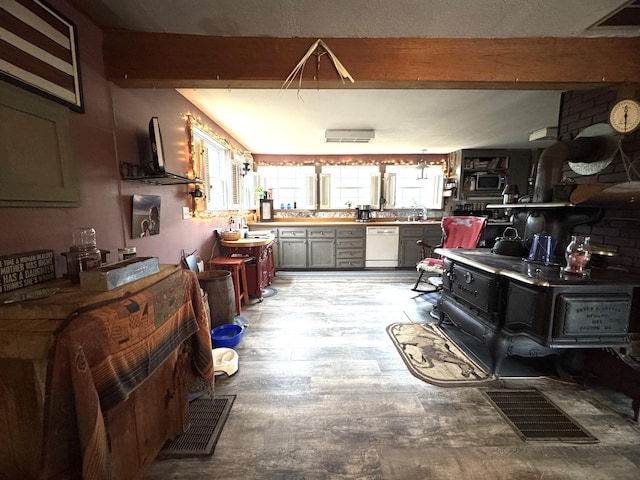 7 Howard Siding Ln, Abbot, ME 04406 - kitchen featuring dishwasher, beam ceiling, and stainless steel microwave