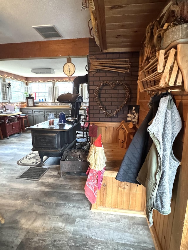 7 Howard Siding Ln, Abbot, ME 04406 - living area with wood finished floors, a wood stove, and beam ceiling