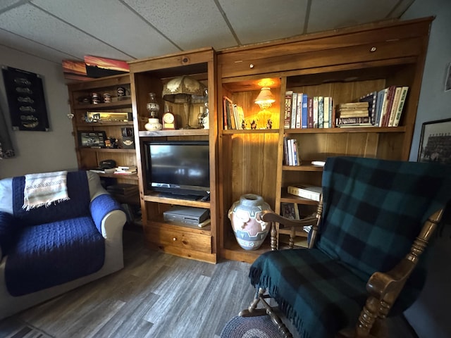 7 Howard Siding Ln, Abbot, ME 04406 - sitting room featuring wood finished floors and a drop ceiling