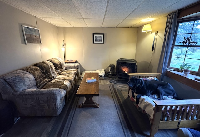7 Howard Siding Ln, Abbot, ME 04406 - carpeted living room with a wood stove and a paneled ceiling