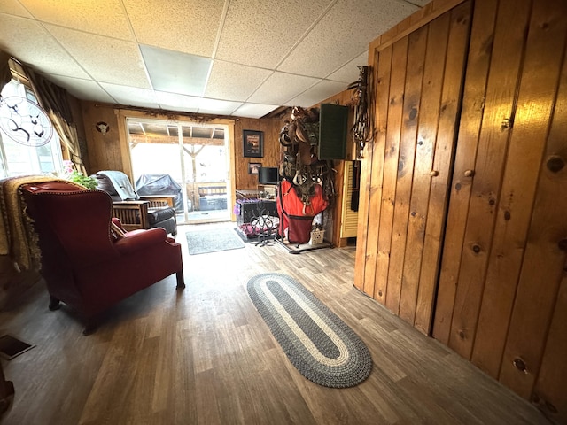 7 Howard Siding Ln, Abbot, ME 04406 - sitting room featuring wood finished floors, a paneled ceiling, and wood walls