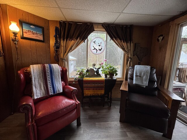 7 Howard Siding Ln, Abbot, ME 04406 - living area with a drop ceiling, wooden walls, healthy amount of natural light, and wood finished floors