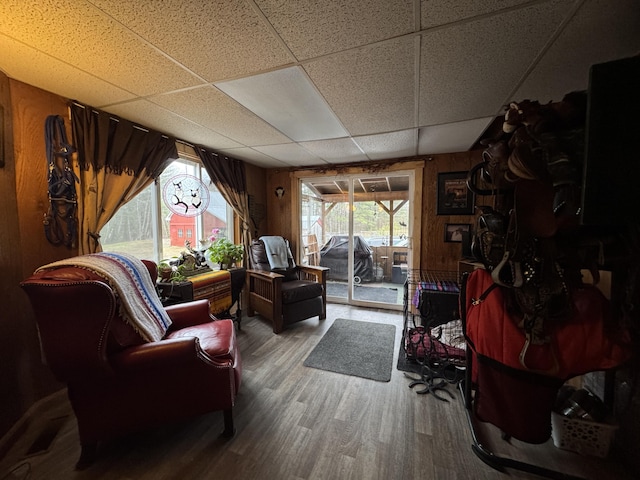 7 Howard Siding Ln, Abbot, ME 04406 - living area featuring a paneled ceiling, wood finished floors, and wood walls
