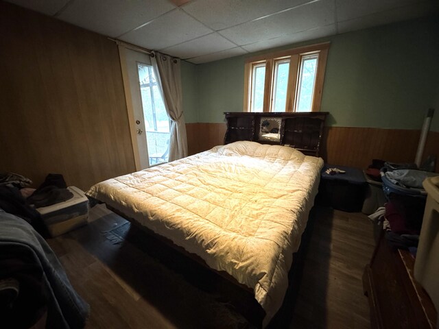 7 Howard Siding Ln, Abbot, ME 04406 - bedroom with a drop ceiling, wood walls, a wainscoted wall, and wood finished floors