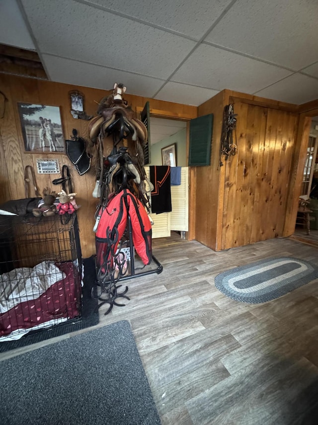 7 Howard Siding Ln, Abbot, ME 04406 - interior space featuring a drop ceiling, wood finished floors, and wooden walls
