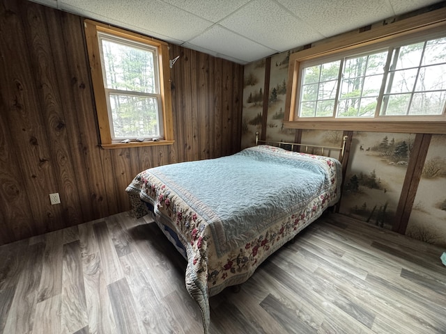 7 Howard Siding Ln, Abbot, ME 04406 - bedroom featuring a paneled ceiling, wood finished floors, and wood walls