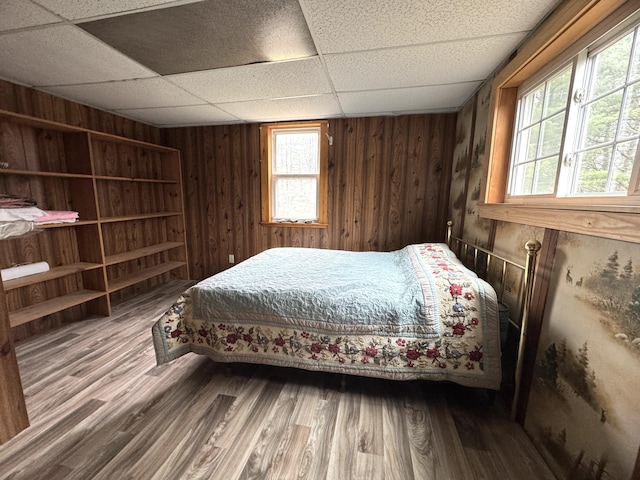 7 Howard Siding Ln, Abbot, ME 04406 - bedroom featuring a drop ceiling, wood finished floors, and wood walls