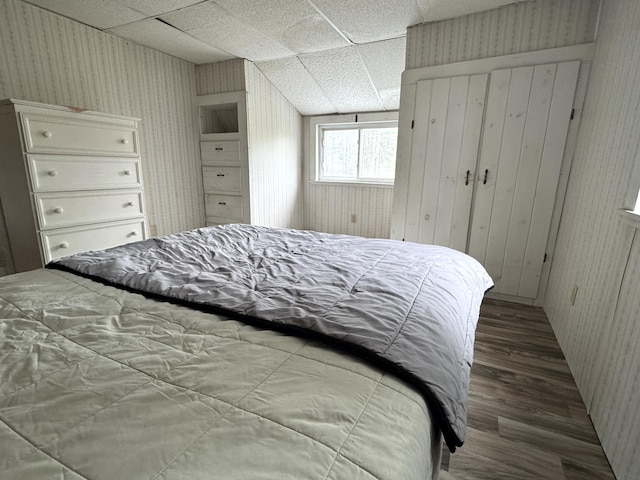 7 Howard Siding Ln, Abbot, ME 04406 - bedroom with wood finished floors, a drop ceiling, and wallpapered walls