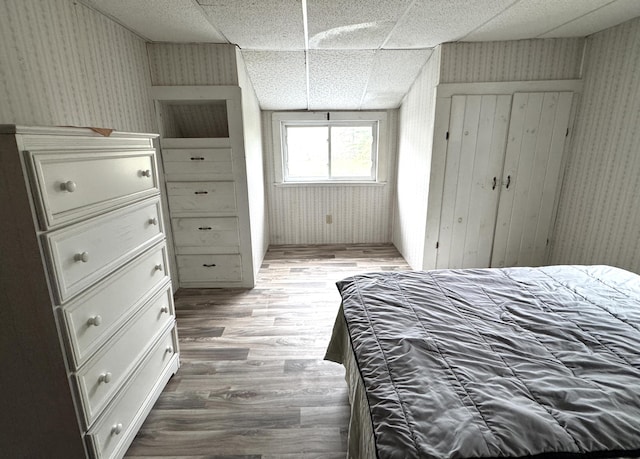 7 Howard Siding Ln, Abbot, ME 04406 - bedroom featuring wallpapered walls, wood finished floors, and a paneled ceiling