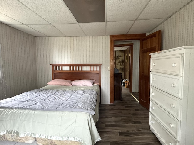 7 Howard Siding Ln, Abbot, ME 04406 - bedroom featuring wallpapered walls, dark wood-type flooring, and a paneled ceiling