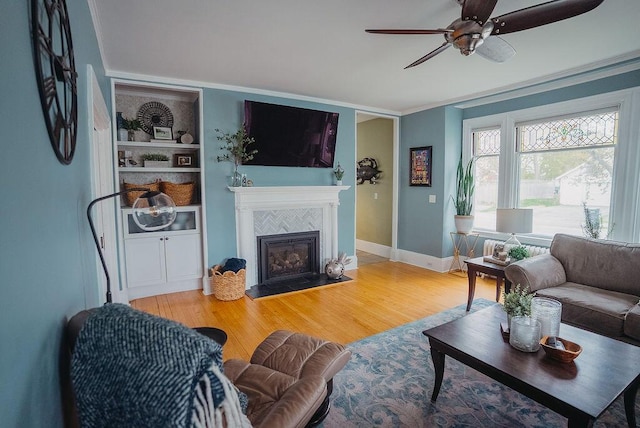 107 Maple St, Bangor, ME 04401 - living area featuring ceiling fan, a tile fireplace, wood finished floors, baseboards, and ornamental molding