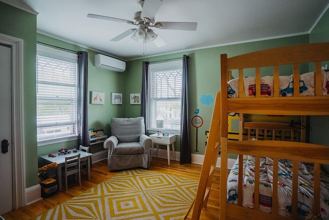 107 Maple St, Bangor, ME 04401 - bedroom with a wall mounted AC, multiple windows, wood finished floors, crown molding, and a ceiling fan