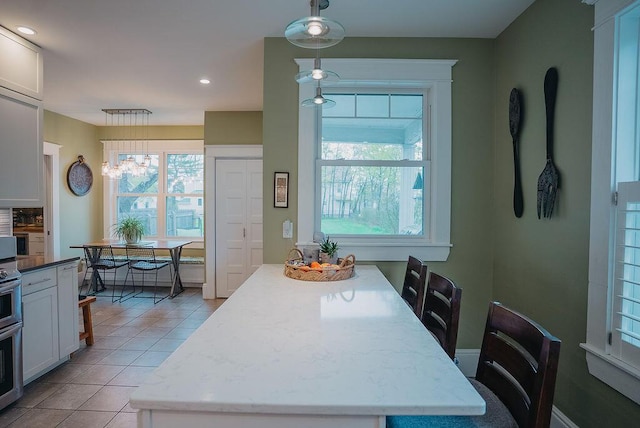 107 Maple St, Bangor, ME 04401 - dining area with light tile patterned floors, plenty of natural light, a chandelier, and recessed lighting