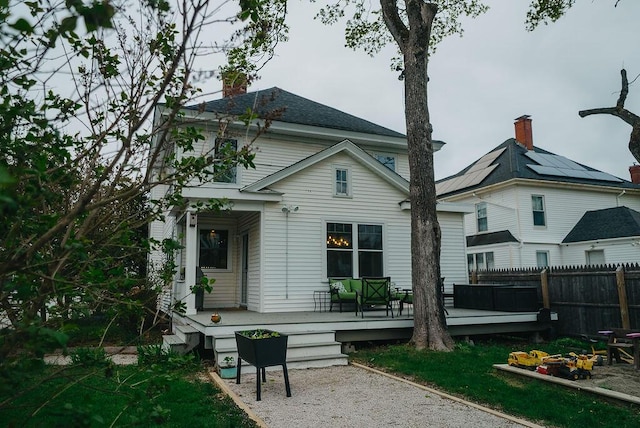 107 Maple St, Bangor, ME 04401 - rear view of property with fence, a chimney, and a wooden deck