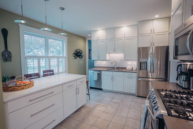 107 Maple St, Bangor, ME 04401 - kitchen with a sink, stainless steel appliances, backsplash, light tile patterned flooring, and white cabinetry
