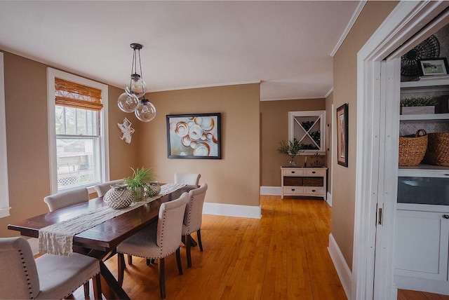 107 Maple St, Bangor, ME 04401 - dining room with baseboards, light wood-type flooring, and crown molding