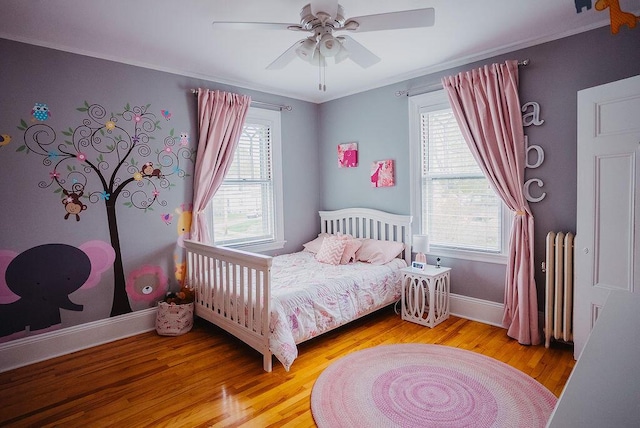 107 Maple St, Bangor, ME 04401 - bedroom featuring wood finished floors, baseboards, radiator heating unit, crown molding, and a ceiling fan