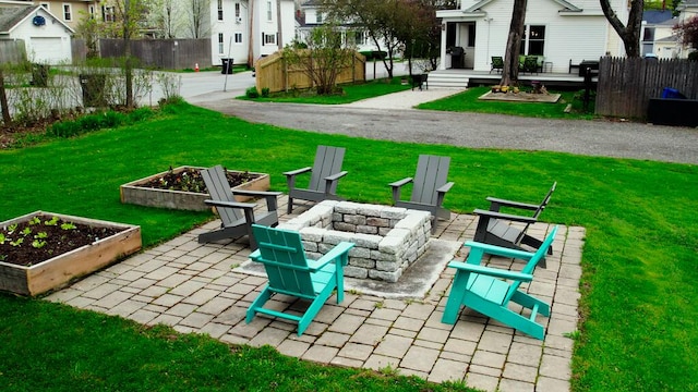 107 Maple St, Bangor, ME 04401 - view of patio featuring an outdoor fire pit, a garden, and a residential view