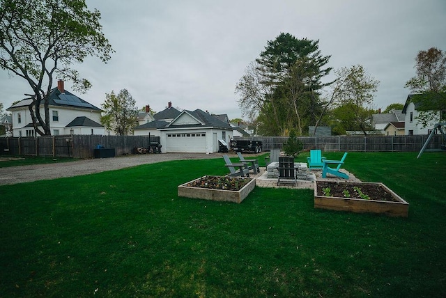 107 Maple St, Bangor, ME 04401 - view of yard featuring a vegetable garden, driveway, and an attached garage