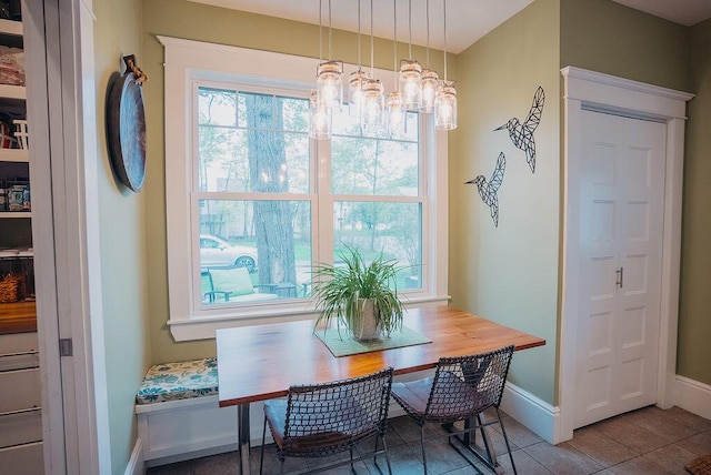 107 Maple St, Bangor, ME 04401 - tiled dining area featuring baseboards and a chandelier