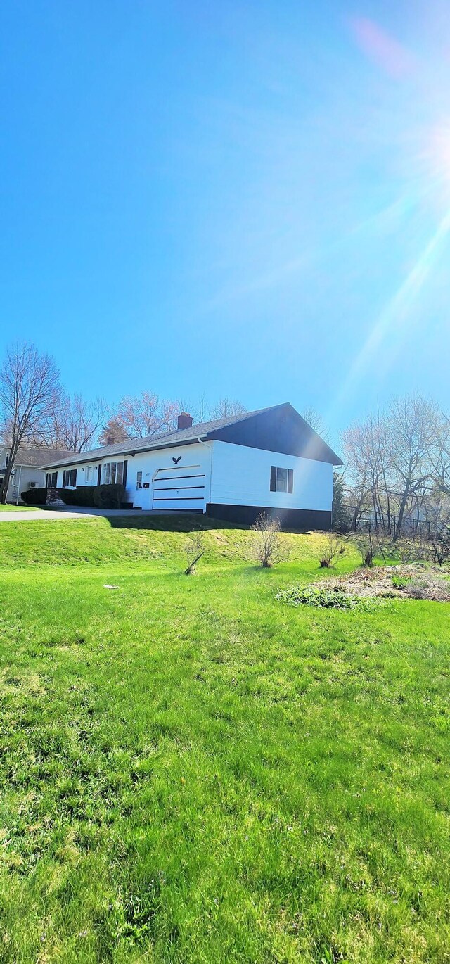 back of property with a lawn