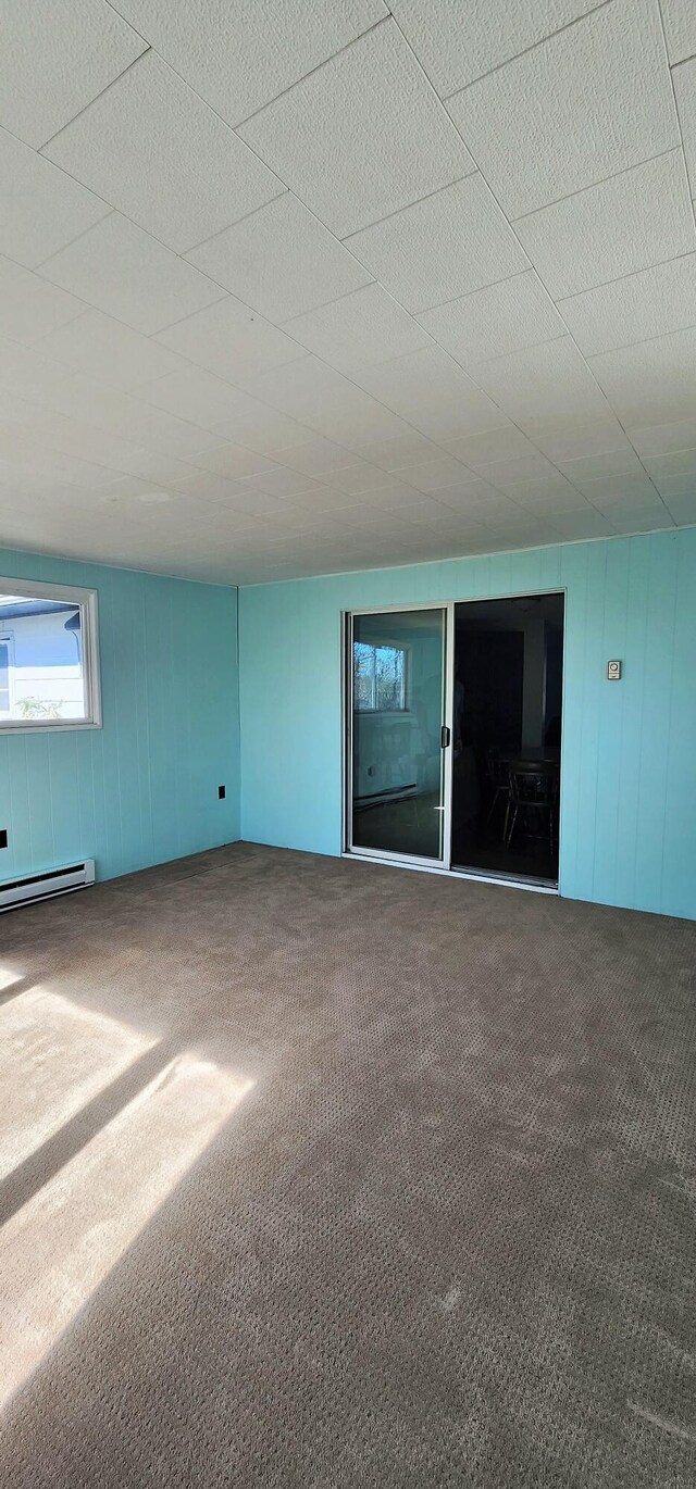 spare room featuring carpet and a baseboard radiator