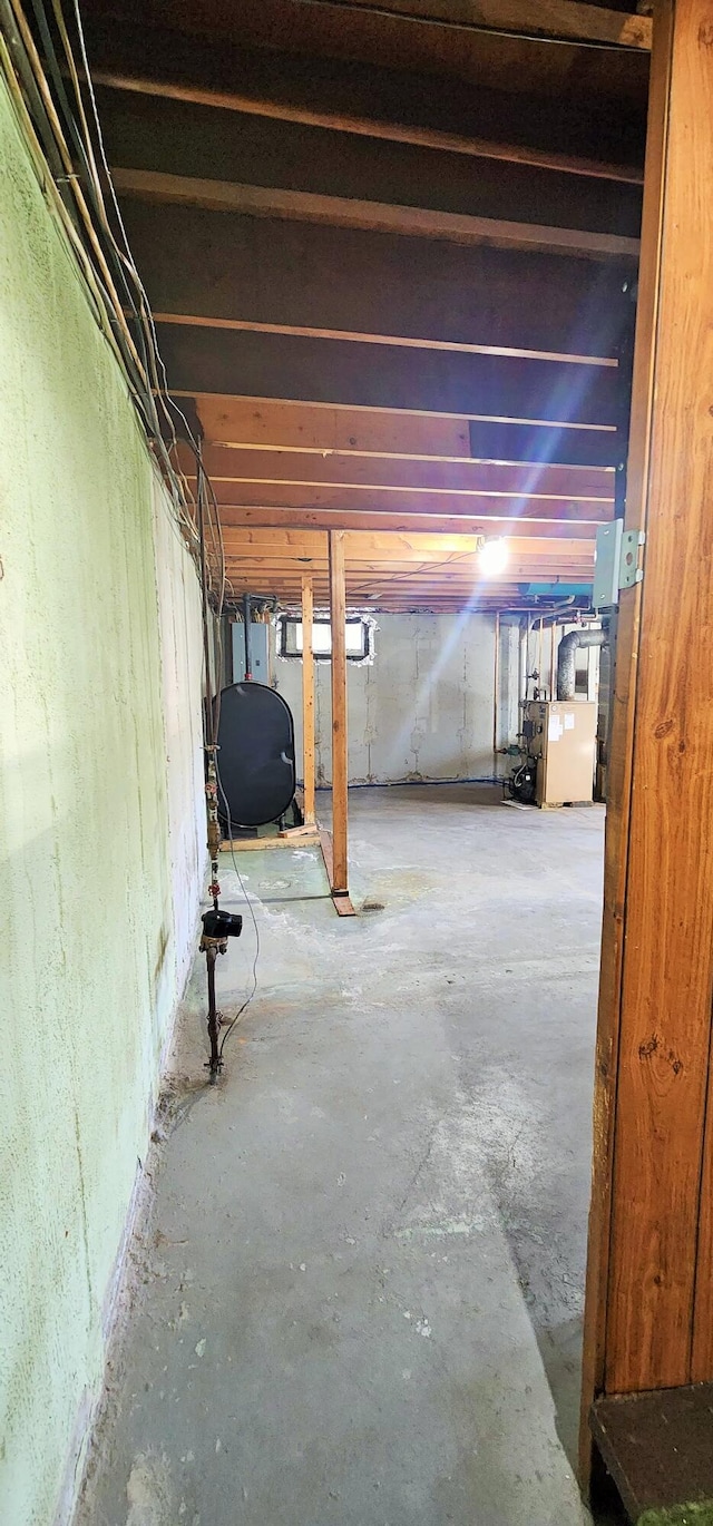 unfinished below grade area featuring oil tank