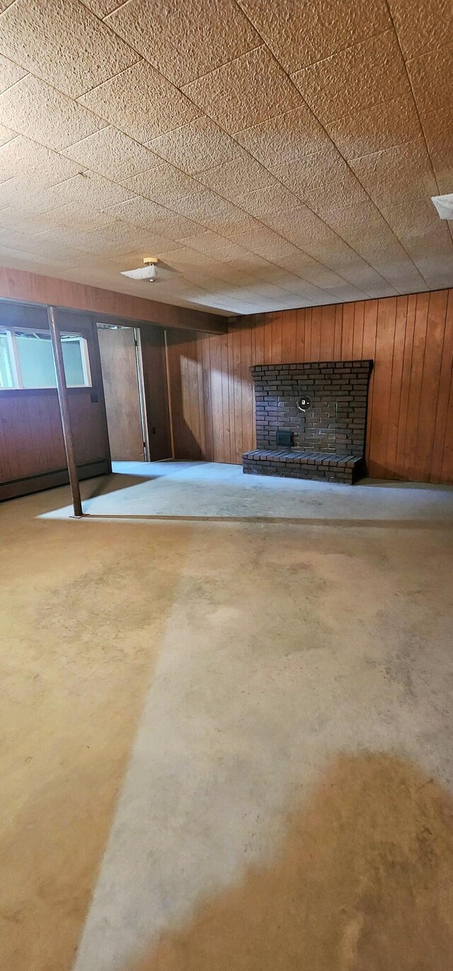 basement featuring wood walls