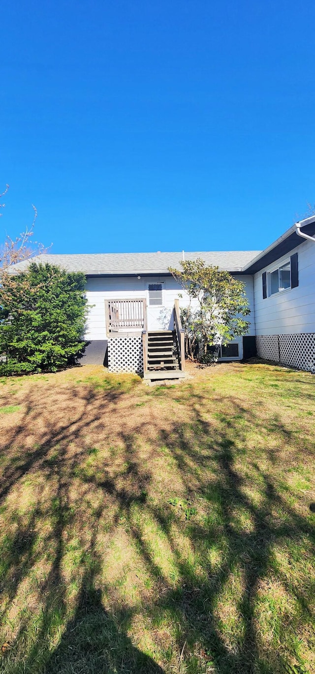 back of house featuring a yard and a deck