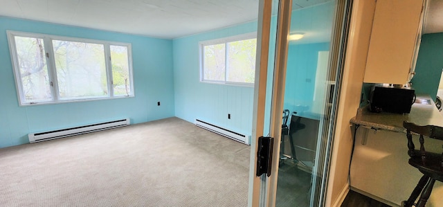 400 Birch St, Bangor, ME 04401 - carpeted empty room with a baseboard radiator, baseboard heating, and healthy amount of natural light