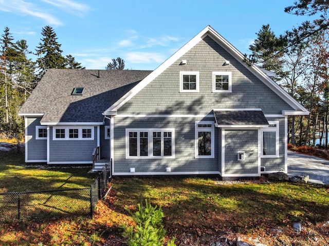 rear view of property with roof with shingles