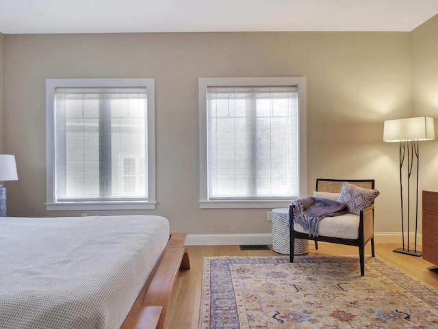 bedroom featuring wood finished floors and baseboards