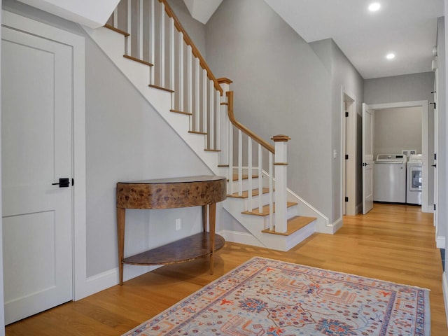 entryway featuring washer and dryer, baseboards, wood finished floors, and recessed lighting